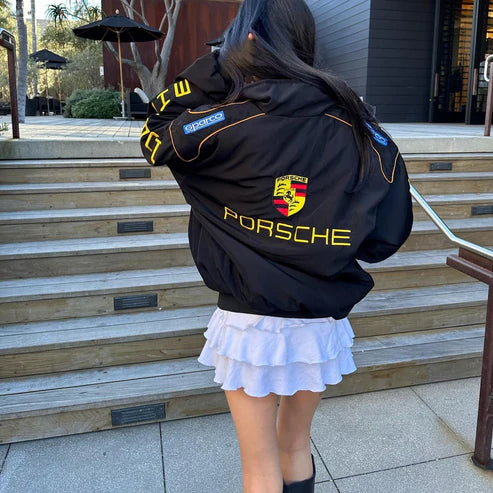 Black racing jacket with yellow PORSCHE back text and crest emblem