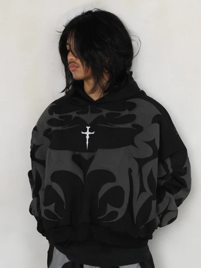Model wearing Tribal Shadow Delta Hoodie in casual streetwear setting
