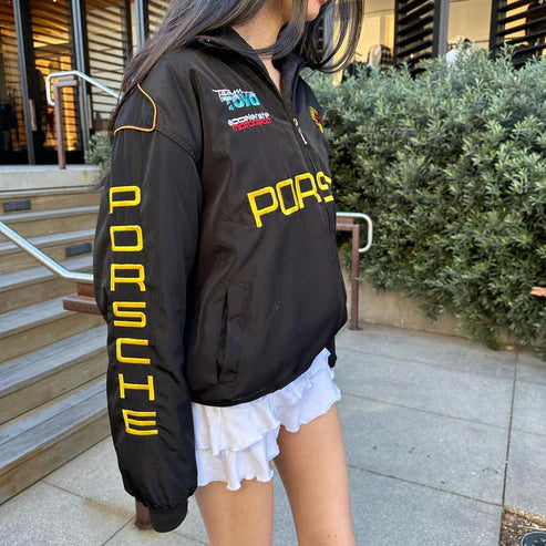 Black zip-up racing jacket with yellow Porsche PORSCH front logo and sleeve detail