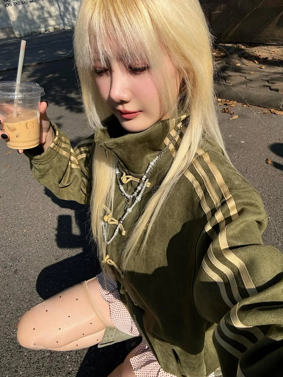 olive green oversized CNY jacket styled with sunglasses streetwear look