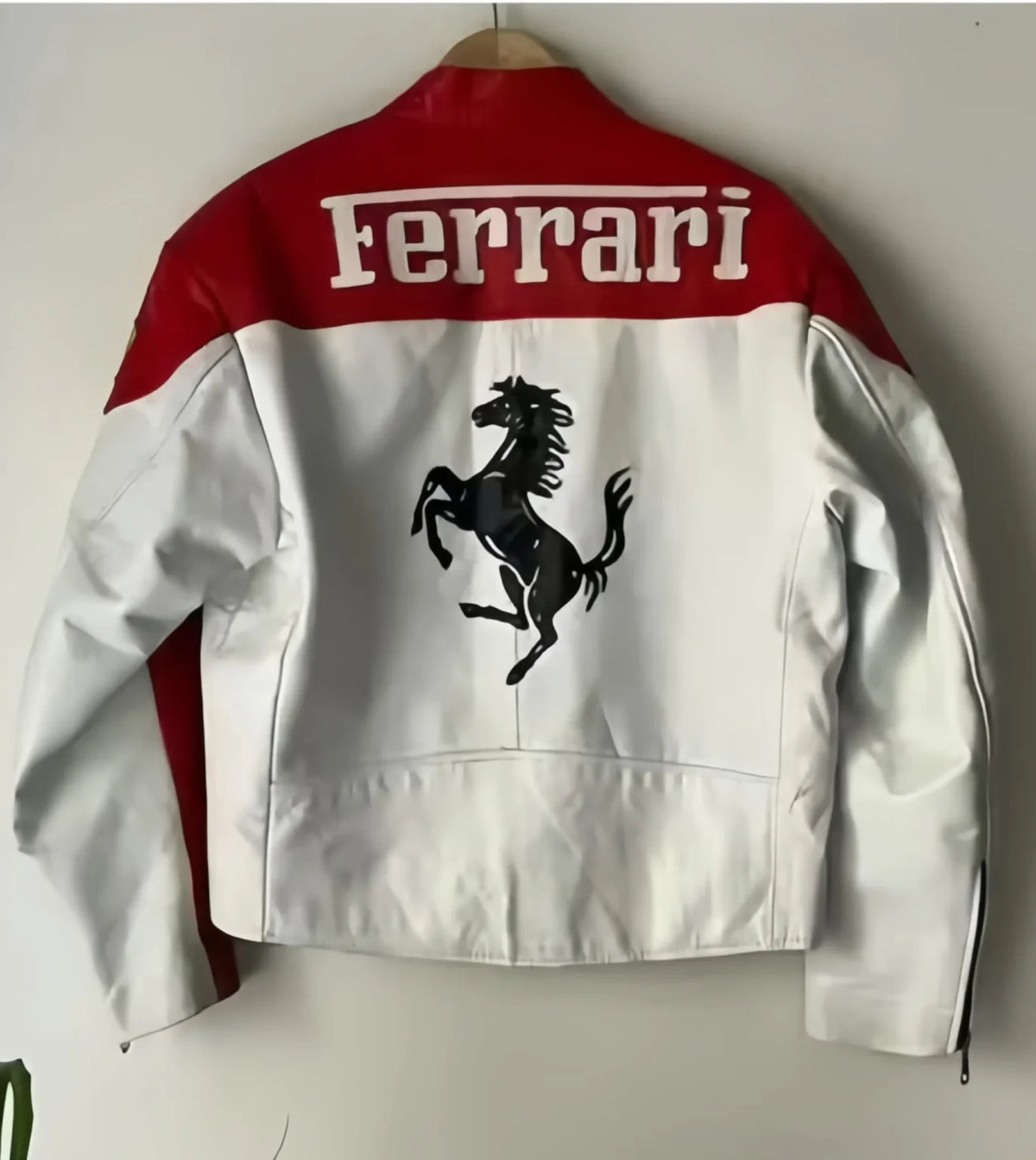 Red and white leather jacket, back shows Ferrari text and prancing horse emblem