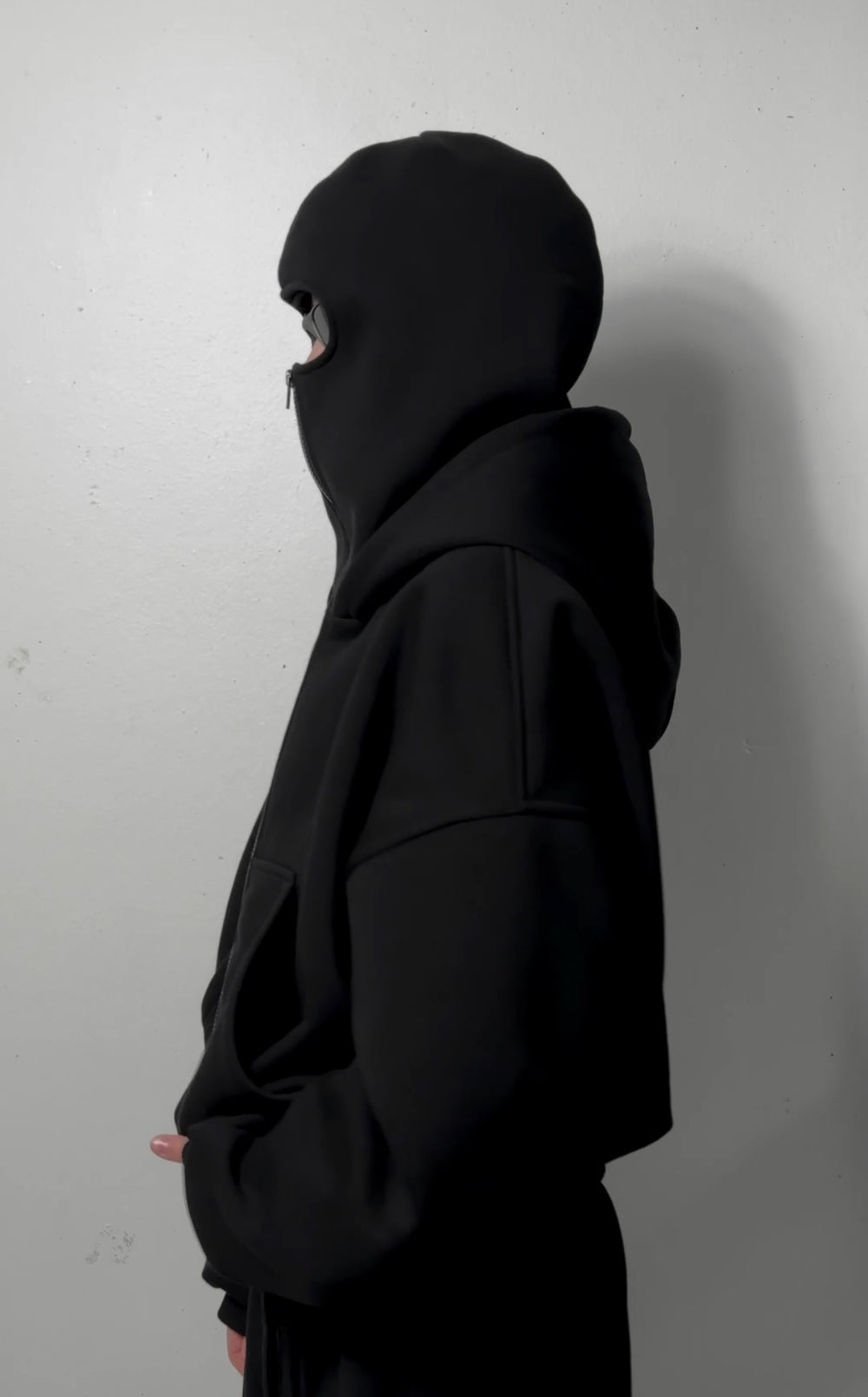 Black layered balaclava zip-up hoodie with face-covering hood and center zipper.