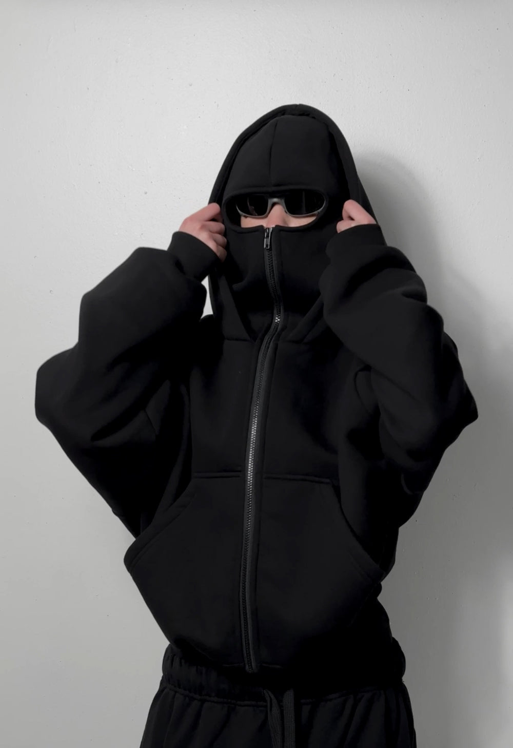 Black balaclava zip-up hoodie with central zipper and front pouch.
