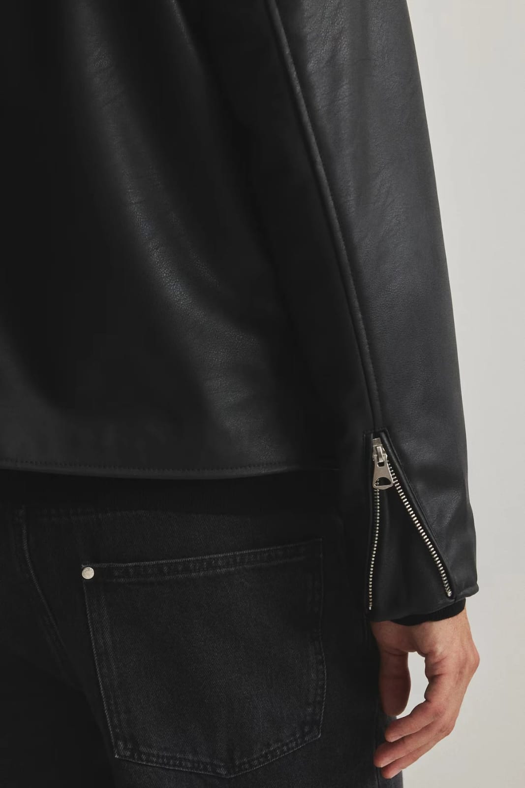 Black leather sleeve with zipper cuff detail and matte finish