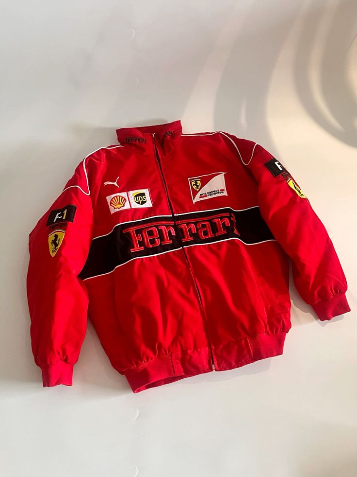 Red Ferrari F1 zip jacket with Ferrari script and multi-brand sleeve patches
