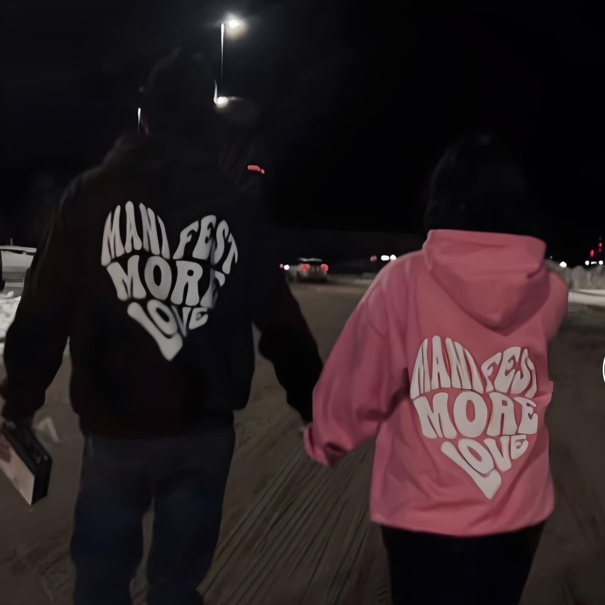 Black and mauve/pink cotton couple hoodies with 'MANIFEST MORE LOVE' heart print on back