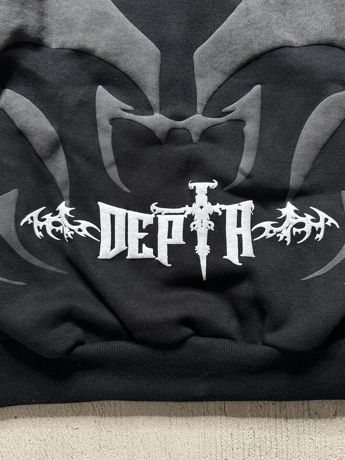 Close-up of Tribal Shadow Delta Hoodie fabric texture and logo details
