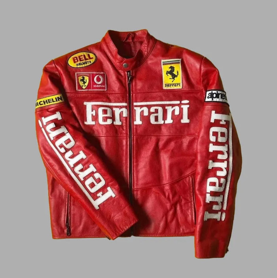Red moto jacket with front zipper, stand collar, Ferrari chest logo, and racing patches