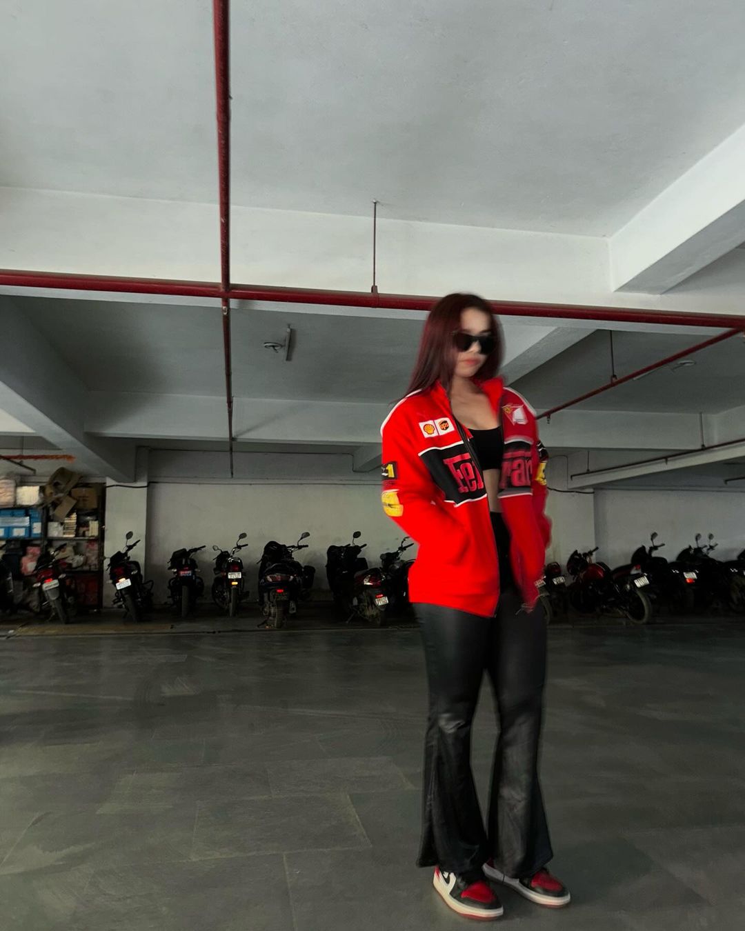 Red racing style zip-up jacket with white piping, patch logos and racing crest