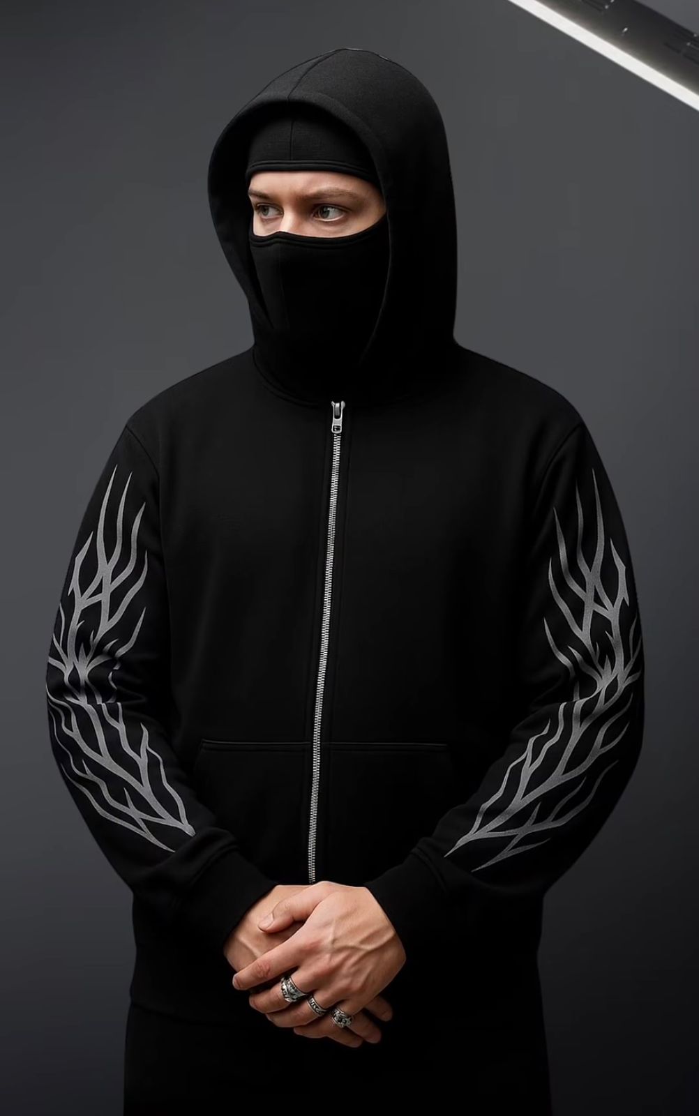 Black balaclava hoodie with front zipper and white flame sleeve prints.