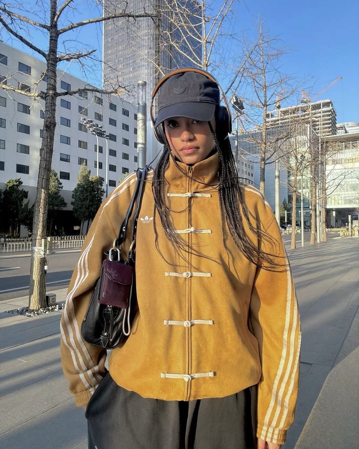 Mustard yellow suede jacket with stand collar, toggle buttons, and white sleeve stripes