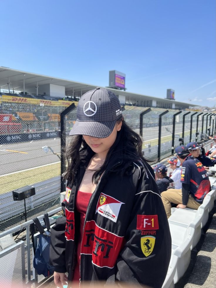 Black bomber jacket with red F1 panel and Ferrari shield patch, zip front
