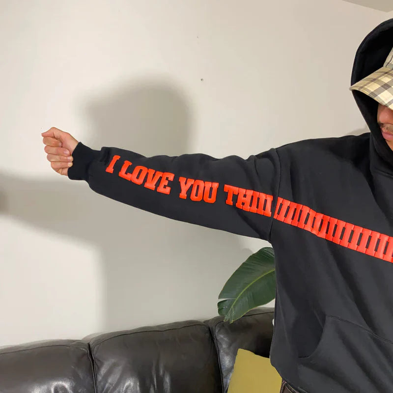 Black hoodie sleeve with red ‘I LOVE YOU THIS MUCH’ text graphic