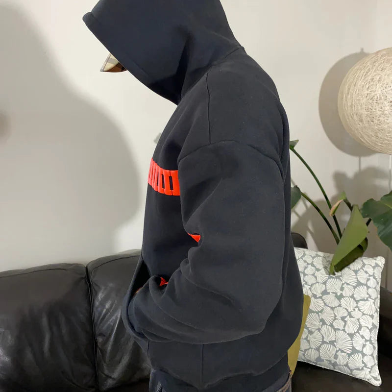 Black oversized hoodie with red graphic text and kangaroo pocket