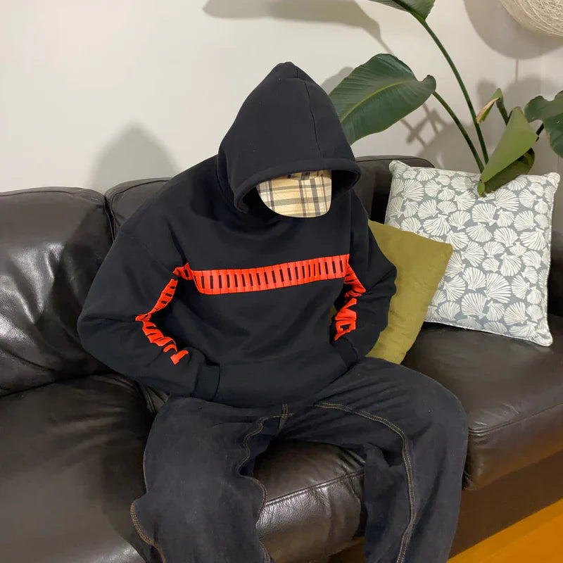 Black oversized hoodie with red ‘I LOVE YOU THIS MUCH’ text; plaid hood lining