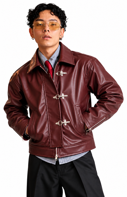 Mercywear burgundy leather-look jacket for men featuring vintage silver metal buckles, front zipper and relaxed boxy fit.