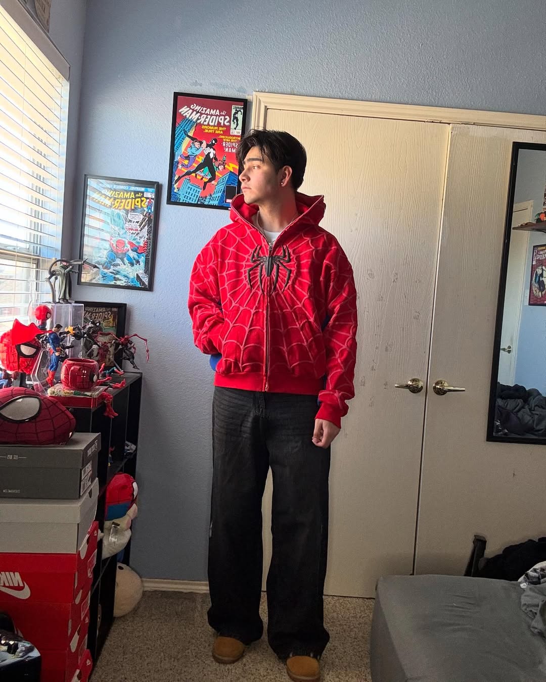 Red full-zip spider-web hoodie with blue sleeve panels and drawstring hood