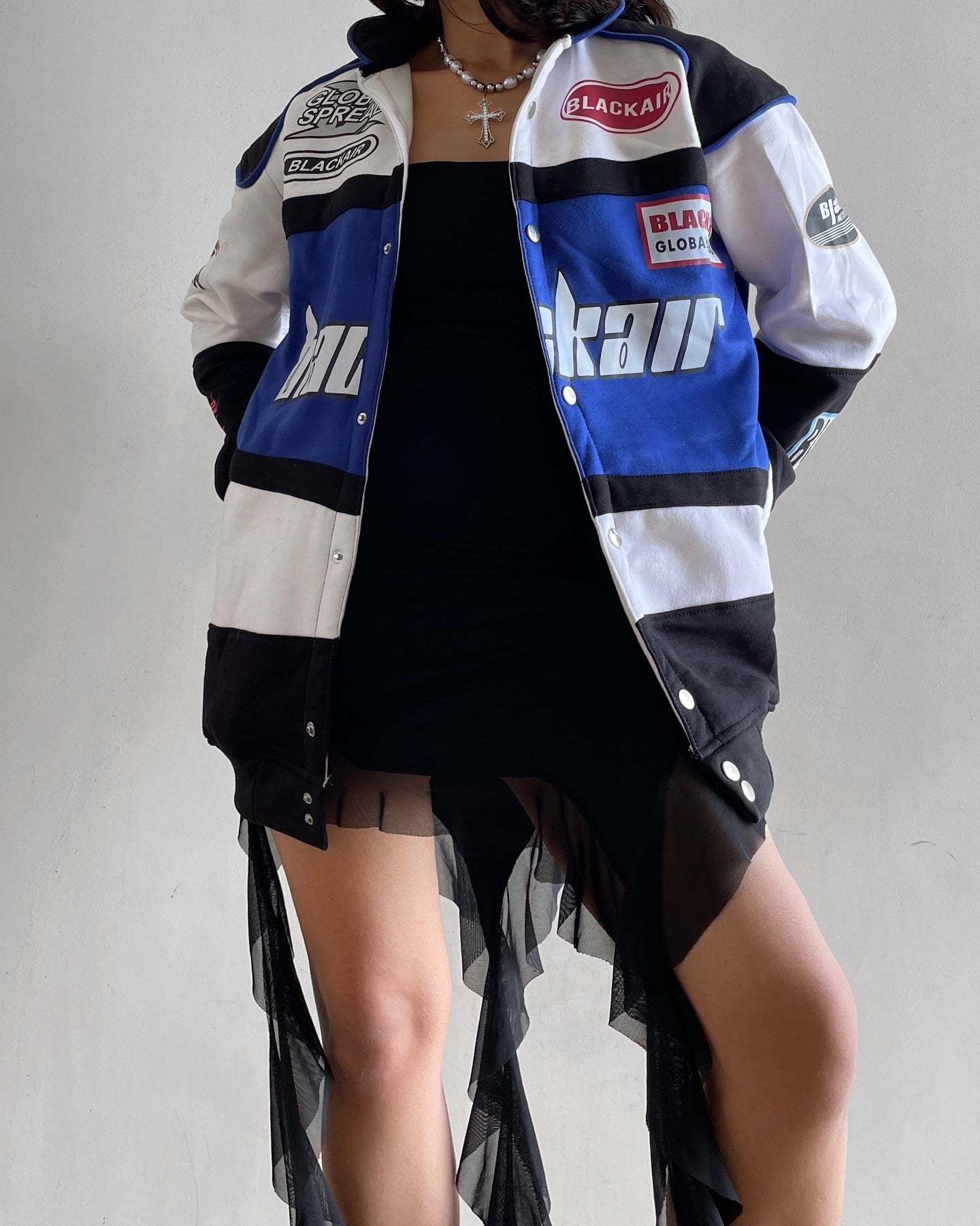 Close-up of Jacket Details - Black Air Racing Jacket with Zipper and Logo Detailing